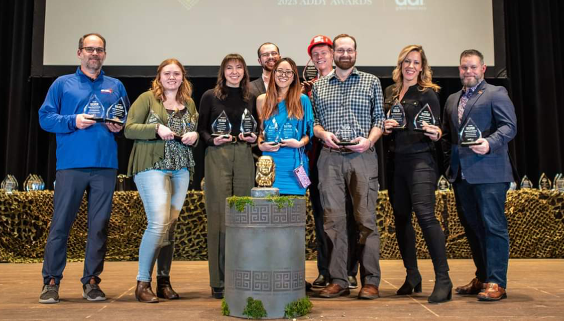 group shot of people holding crystal awards